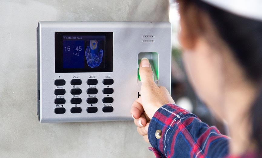 An employee uses biometric scanning for time tracking