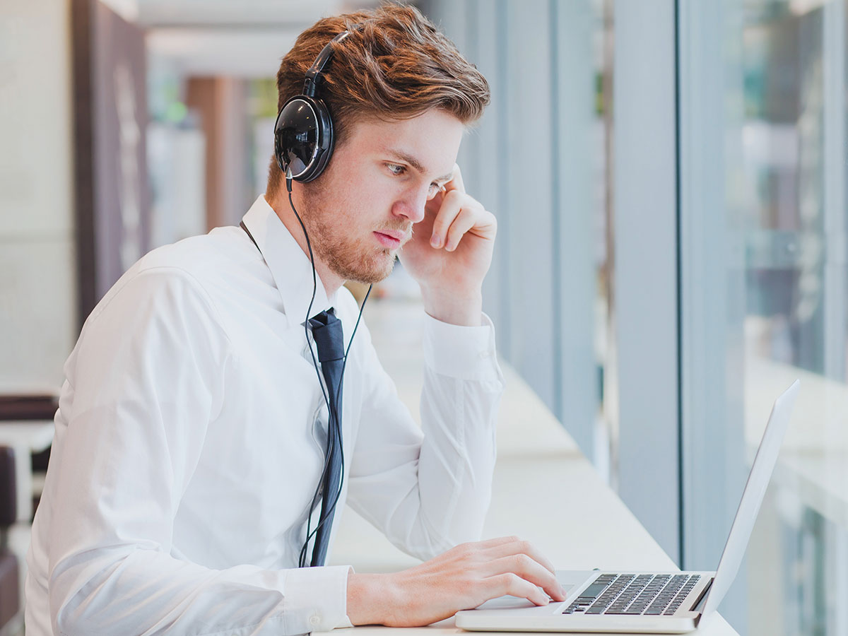 man looking on his computer