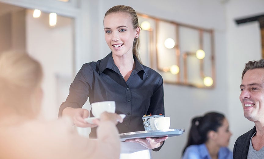 waitress serving customers in restaurant