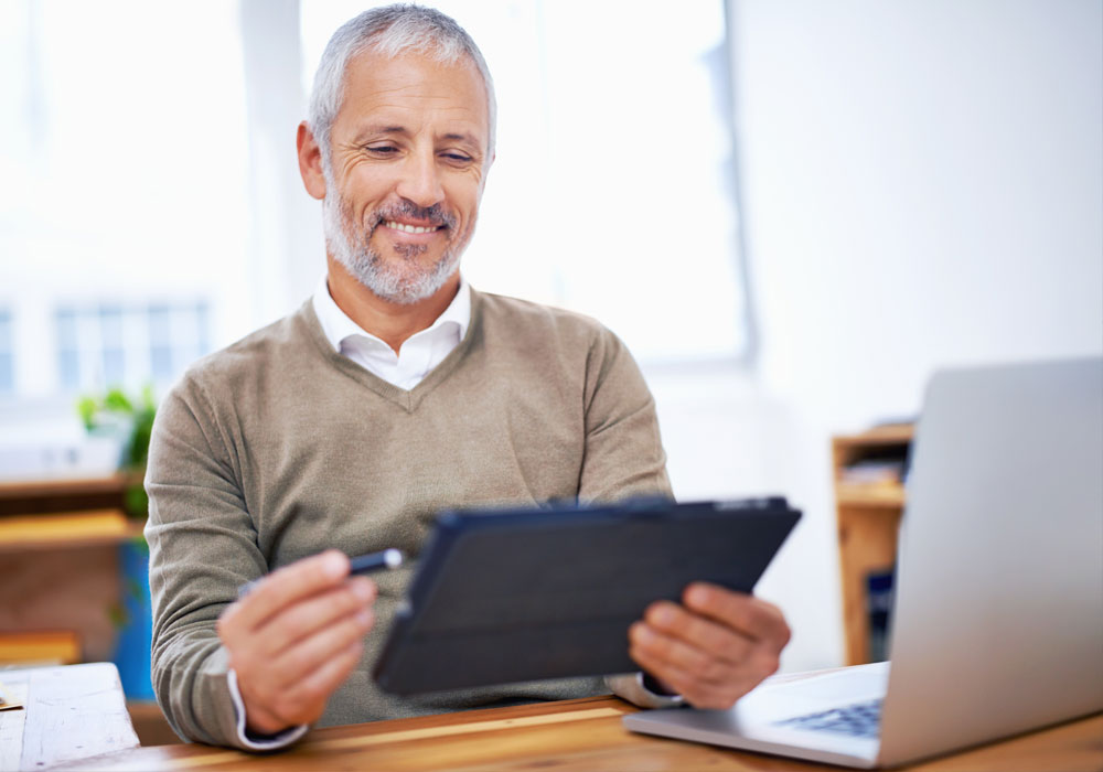 man looking at tablet