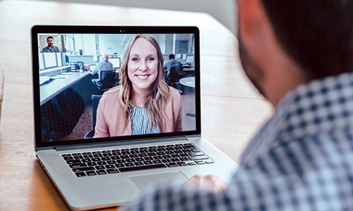 Two workers video chatting.