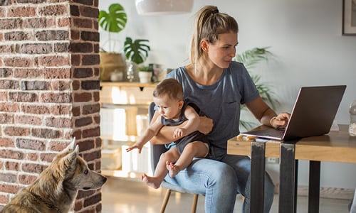 Woman working with baby on lap