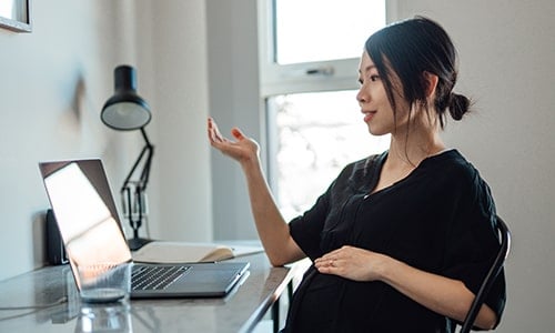 business woman looking at computer reviewing top regulatory issues