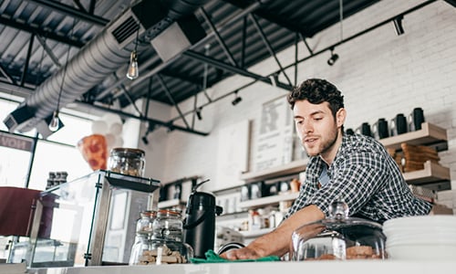 Man working at cafe counter