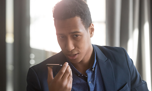 Man talking to mobile phone to run payroll with Paychex Voice Assist