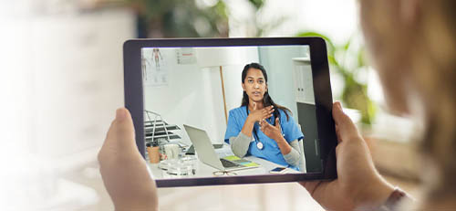 employee using talking to their doctor on a video call