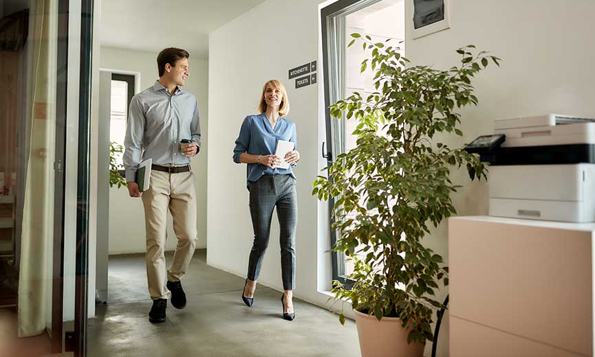 two colleagues walking into the office and discussing boomerang employees