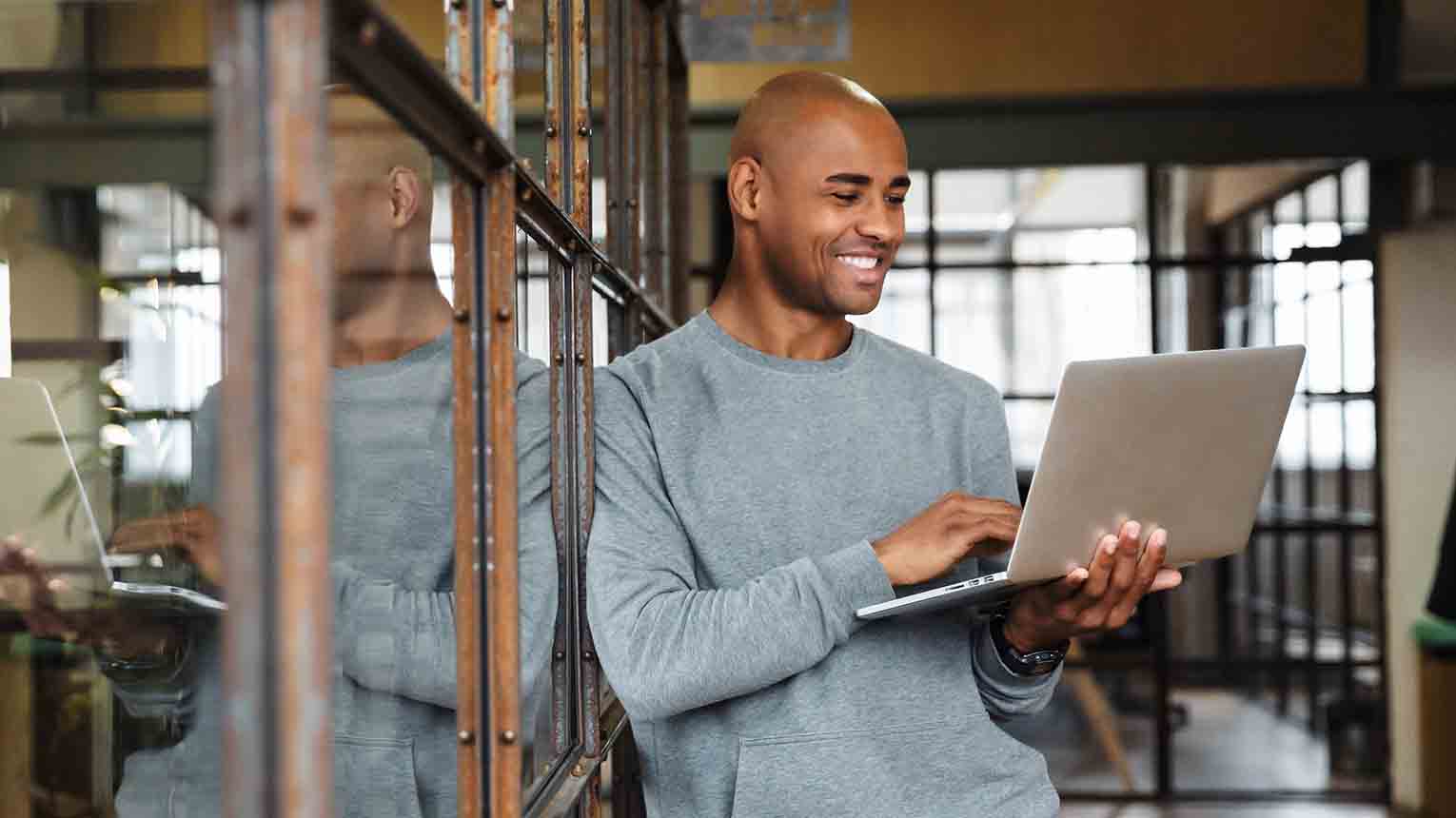 a happy businessman researching about the calsavers retirement program on his laptop