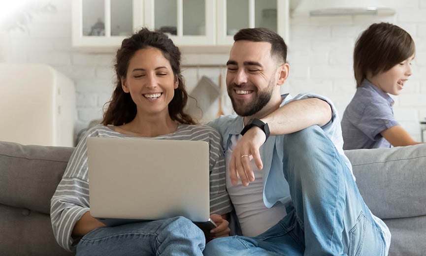 a happy couple reviewing their employee benefits package