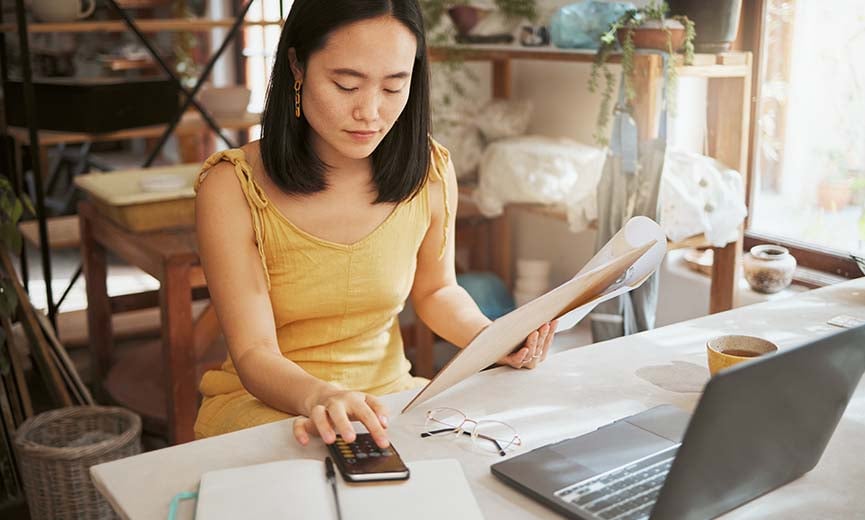 A small business owner calculates gross and net income to help with financial analysis