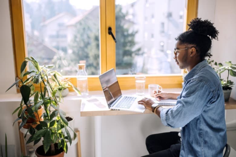 Women running payroll on laptop