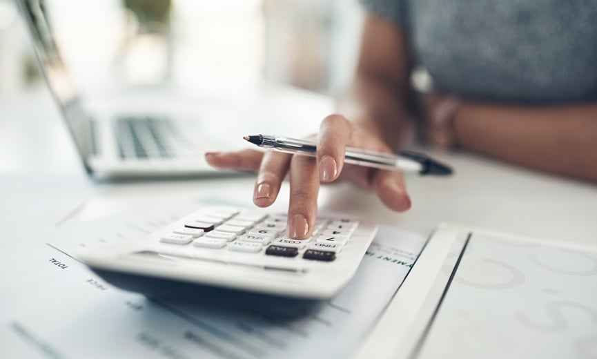 Business owner calculating total compensation for employees