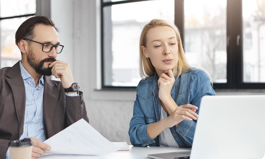 Two professionals auditing their employee benefit plan