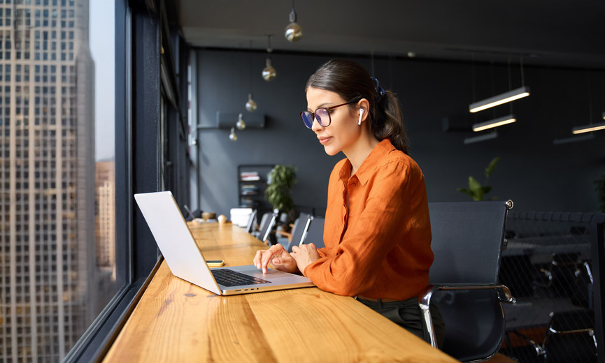 Young woman working in a high rise thinking about retirement