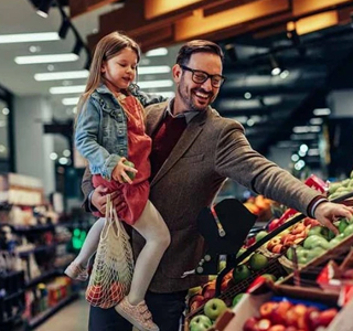 Father shopping with daughter in a supermarket