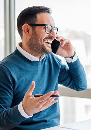 A business owner talking to a Paychex representative on the phone