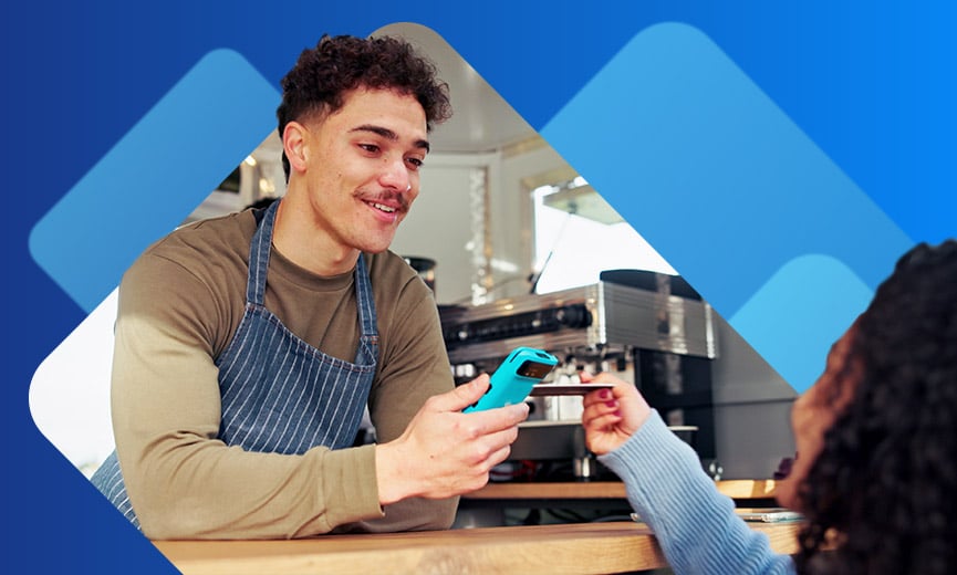 Food truck employee taking payment with cellphone