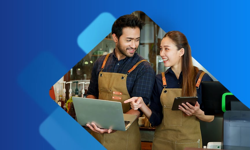 Coffee shop employees looking at payroll