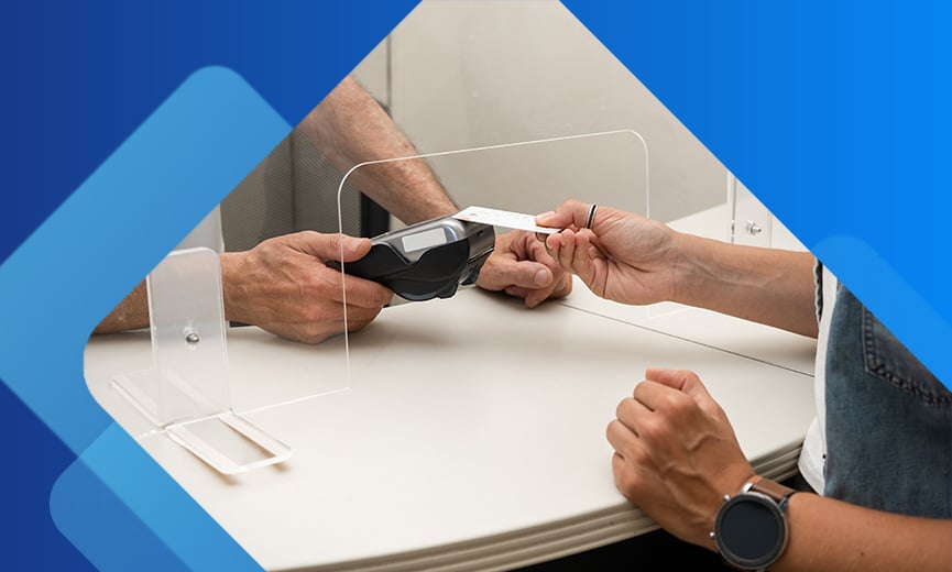 Woman paying at doctors office with credit card
