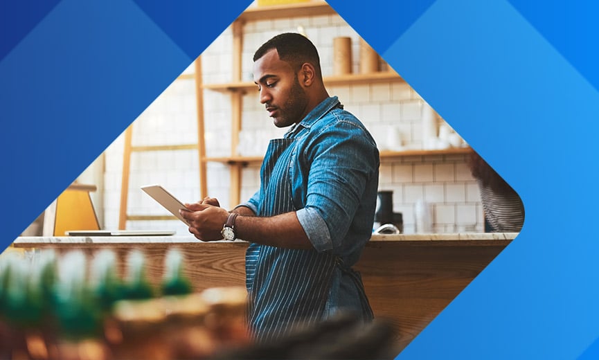 Business owner looking at tablet accessing risk