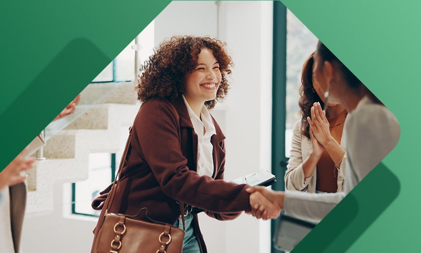 Woman shaking hands with new coworkers