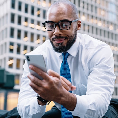 Business man checking his finances on cell phone
