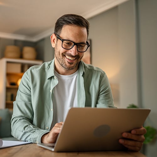 Man comparing paychex packages on laptop