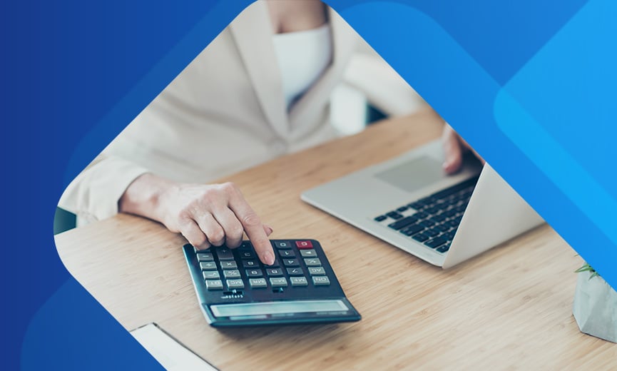 Business owner doing manual calculations wishing her payroll was automated
