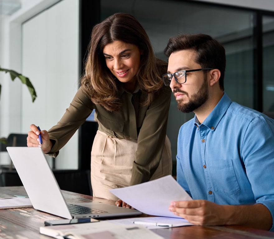 A business owner helping an employee