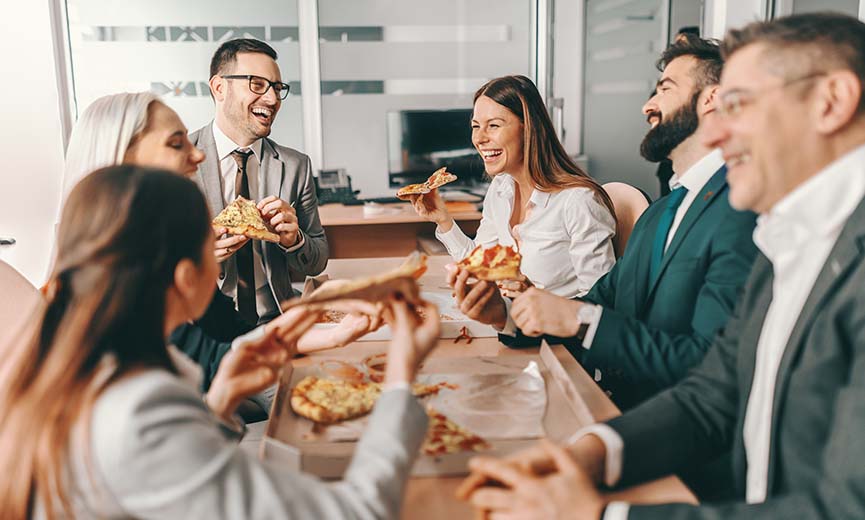 employees enjoying a perk of a catered lunch at work