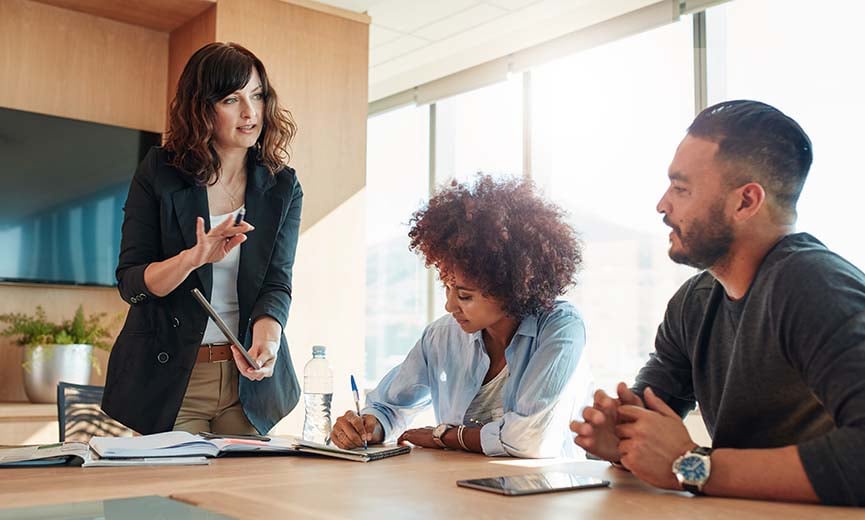 a hr manager discussing challenges of compensation management with her subordinates