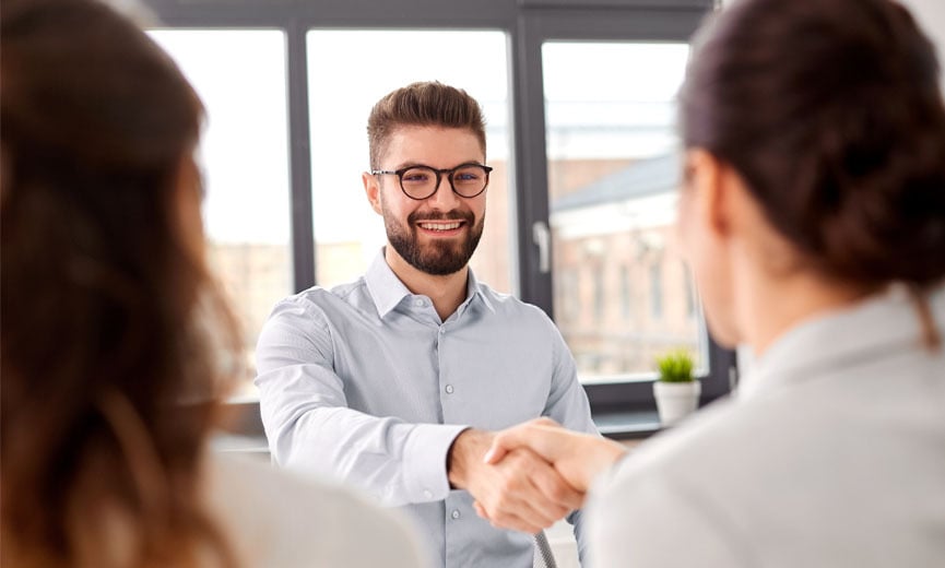 A new hire discusses benefit enrollment with his manager
