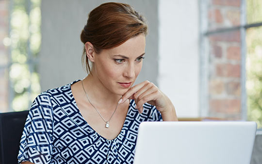 A business owner reading an FAQ about returning to work