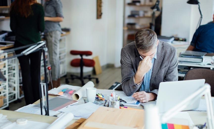 Man looking stressed at desk
