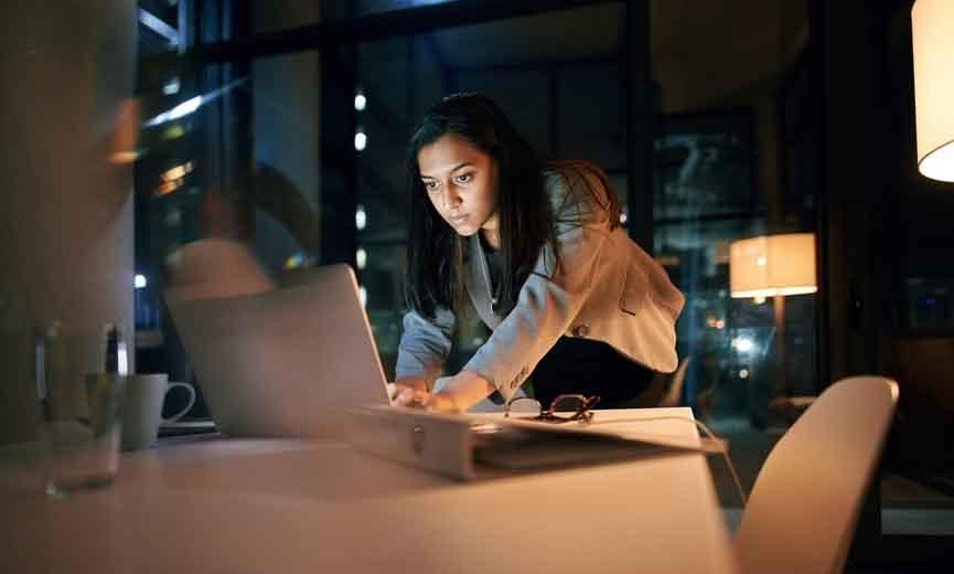 woman working on her laptop at night