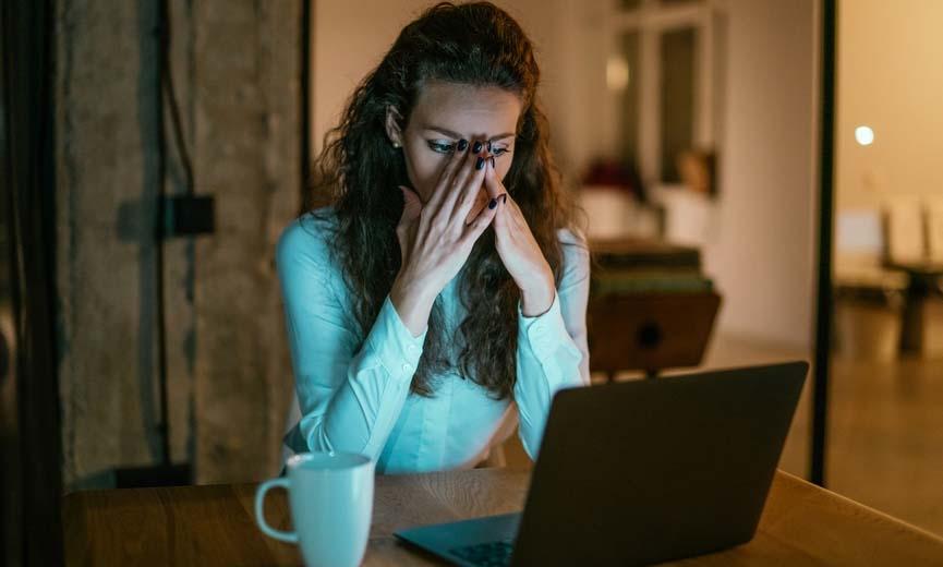 Stressed woman working from home at night