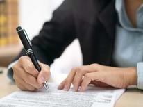 Una mujer completa un formulario W-4 antes de empezar su relación laboral. 