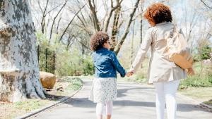 A mother takes time off to spend with her daughter at a park.