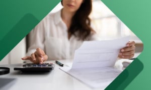 Business woman updating her ledger 