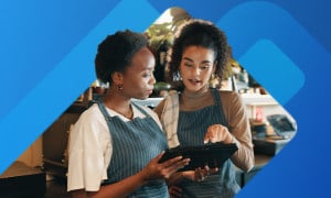 Two restaurant employees checking regulations on tablet