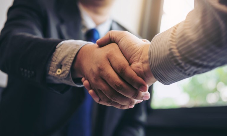 Shaking hands before negotiating workplace benefits