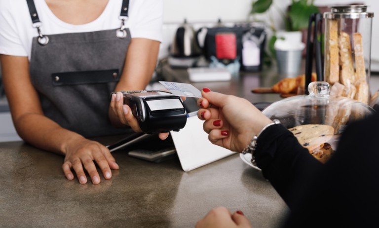 Una clienta pagando comida con tarjeta de crédito