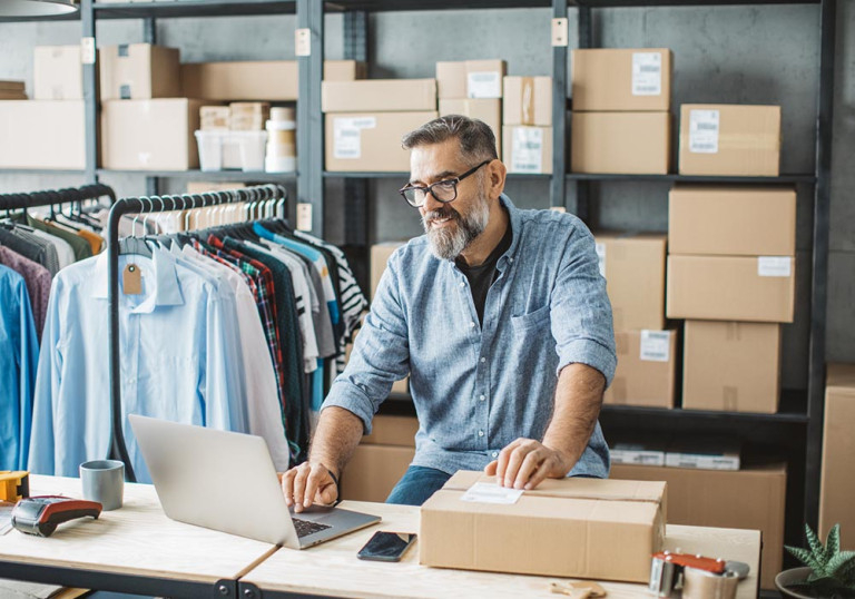 an employee boxing up merchandise to ship