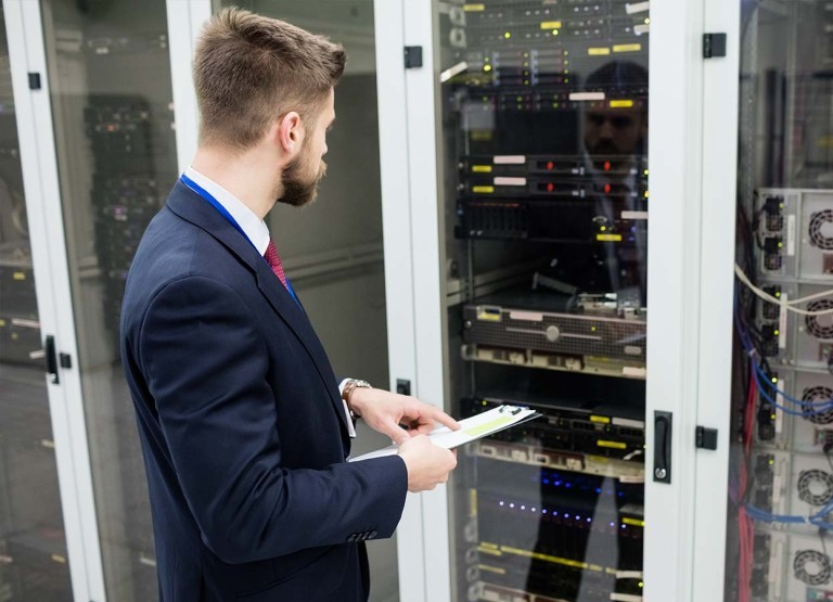 employee reviewing checklist in server room