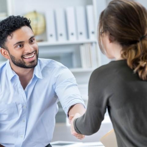 an hr manager shaking hand with a new employee