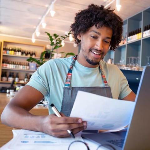 A small business owner uses a payroll software to manage payroll