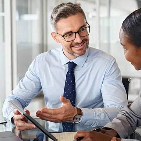 two coworkers discussing safe harbor 401(k) provision 