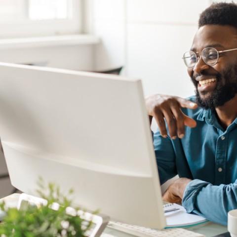 a smiling man working in his office