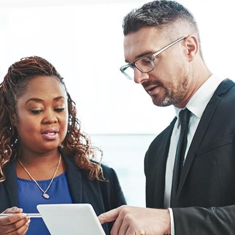 two executives looking at a tablet