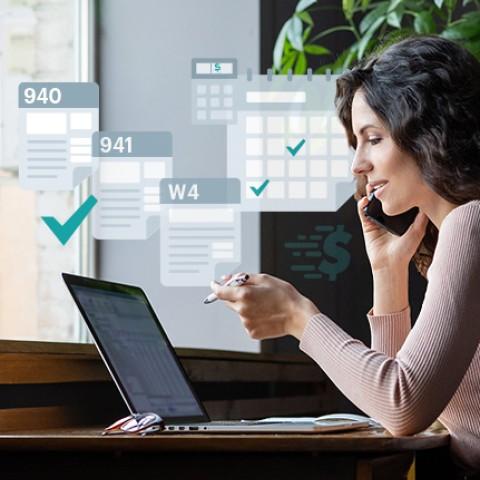 woman doing payroll in her laptop
